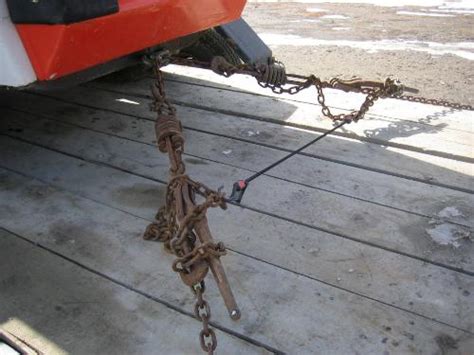 how to secure down a skid steer on a trailer|skidsteer bobcat chain to trailer.